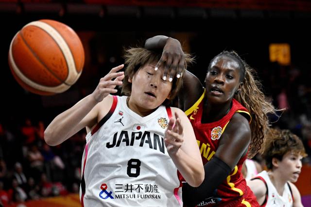 Spain's center #11 Awa Fam (R) and Japan's center #08 Maki Takada vie for the ball during the 2026 FIBA Women's Basketball World Cup Group A match between Japan and Spain in Berlin on September 7, 2026. (Photo by Tobias SCHWARZ / AFP)