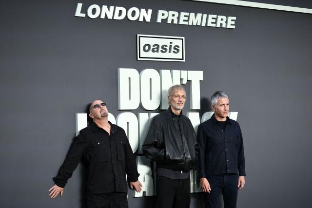 British Musician Paul "Bonehead" Arthurs (L) Welsh Musician Andy Bell (C) and British Musician Gem Archer pose upon arrival on the red carpet for the UK premiere of the film 'Oasis: Don't Look Back In Anger', in Leicester Square in central London on September 7, 2026. (Photo by Henry NICHOLLS / AFP)