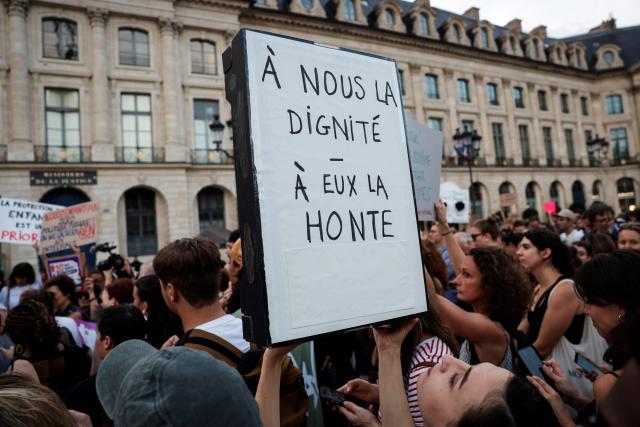 A demonstrator holds a placard reading "Dignity for us, shame for them" during a protest against sexual violence on the day of the examination by a special committee of the National Assembly of a Bill for the protection of women and children, in front of France's Justice ministry at Place Vendome central Paris on September 7, 2026. The full bill, whose objective is to cover the entire chain of violence, from prevention and the identification of victims to the sentencing of perpetrators, reworked this summer after the opinion of the Council of State, and will be discussed at the National Assembly and amended by deputies, before its examination in public session in early October. (Photo by GEOFFROY VAN DER HASSELT / AFP)