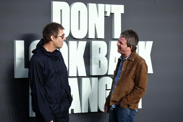 British Musicians and Oasis singers Liam Gallagher (L) Noel Gallagher react as they pose upon arrival on the red carpet for the UK premiere of the film 'Oasis: Don't Look Back In Anger', in Leicester Square in central London on September 7, 2026. (Photo by Henry NICHOLLS / AFP)