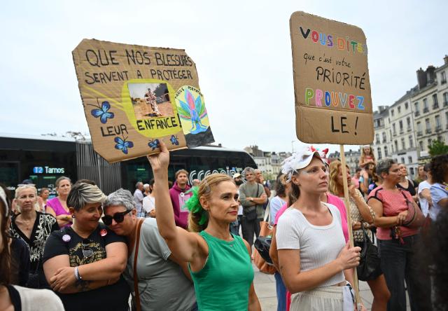 Demonstrators hold placards as they protest outside Bayonne City Hall against sexual violence on the day of the examination by a special committee of the National Assembly of a Bill for the protection of women and children, in Bayonne on September 7, 2026. Following the Lyhanna case- involving an 11-year-old middle school student found raped and murdered in June - a highly anticipated "comprehensive" bill aiming to address the entire spectrum of violence (identification, prevention, support, the justice system and the monitoring of both perpetrators and victims) began its legislative journey on September 7, 2026, being reviewed by a special committee at the National Assembly ahead of its presentation to Parliament in early October. (Photo by Gaizka IROZ / AFP)
