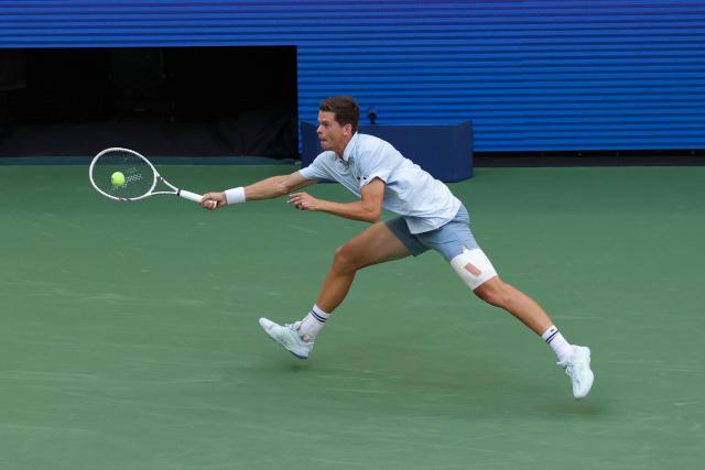 Belgium's Alexander Blockx hits a return to Argentina's Francisco Cerundolo in their men's singles round of 16 tennis match on day nine of the US Open tennis tournament at the USTA Billie Jean King National Tennis Center in New York on September 7, 2026. (Photo by KENA BETANCUR / AFP)