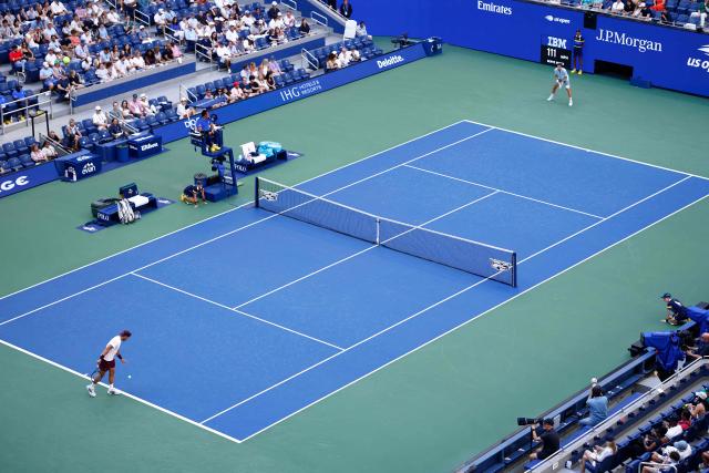 Argentina's Francisco Cerundolo (L) prepares to serve to Belgium's Alexander Blockx (R) during the men's singles round of 16 tennis match on day nine of the US Open tennis tournament at the USTA Billie Jean King National Tennis Center in New York City on September 7, 2026. (Photo by kena betancur / AFP)