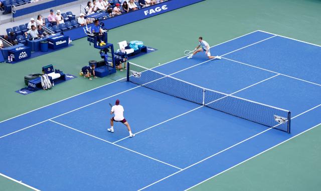 Argentina's Francisco Cerundolo (L) and Belgium's Alexander Blockx play during the men's singles round of 16 tennis match on day nine of the US Open tennis tournament at the USTA Billie Jean King National Tennis Center in New York City on September 7, 2026. (Photo by kena betancur / AFP)