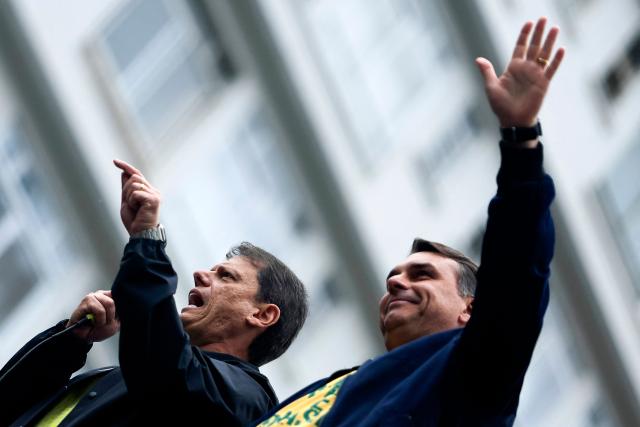Sao Paulo Governor and reelection candidate Tarcisio de Freitas speaks next to Brazil's presidential candidate Flavio Bolsonaro, of the Liberal Party (PL), during a rally held on Independence Day in Sao Paulo, Brazil, on September 7, 2026. (Photo by Miguel SCHINCARIOL / AFP)