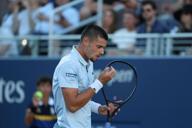 France's Arthur Gea reacts as he plays Netherlands' Botic van de Zandschulp in their men's singles round of 16 tennis match on day nine of the US Open tennis tournament at the USTA Billie Jean King National Tennis Center in New York on September 7, 2026. (Photo by Leonardo MUNOZ / AFP)