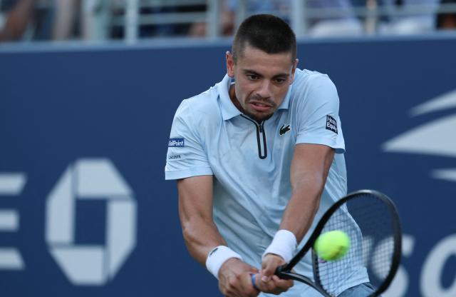 France's Arthur Gea hits a return to Netherlands' Botic van de Zandschulp in their men's singles round of 16 tennis match on day nine of the US Open tennis tournament at the USTA Billie Jean King National Tennis Center in New York on September 7, 2026. (Photo by Leonardo MUNOZ / AFP)