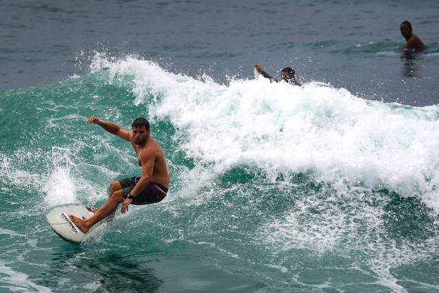 A surfer rides a wave at Electric Beach in Waianae, Hawaii, on September 7, 2026. A hurricane warning was issued September 7 for the westernmost Hawaiian islands of Kauai and Niihau as Category 3 Hurricane Lowell approached the US Pacific island chain, the National Hurricane Center (NHC) said. The core of Lowell was expected to pass just west of Niihau on the night of September 7 or early on September 8, the center said in its latest bulletin released at 8 am Hawaii time (1800GMT). (Photo by Michelle Bir / AFP)