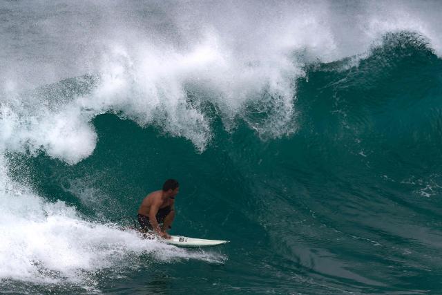 A surfer rides a wave at Electric Beach in Waianae, Hawaii, on September 7, 2026. A hurricane warning was issued September 7 for the westernmost Hawaiian islands of Kauai and Niihau as Category 3 Hurricane Lowell approached the US Pacific island chain, the National Hurricane Center (NHC) said. The core of Lowell was expected to pass just west of Niihau on the night of September 7 or early on September 8, the center said in its latest bulletin released at 8 am Hawaii time (1800GMT). (Photo by Michelle Bir / AFP)