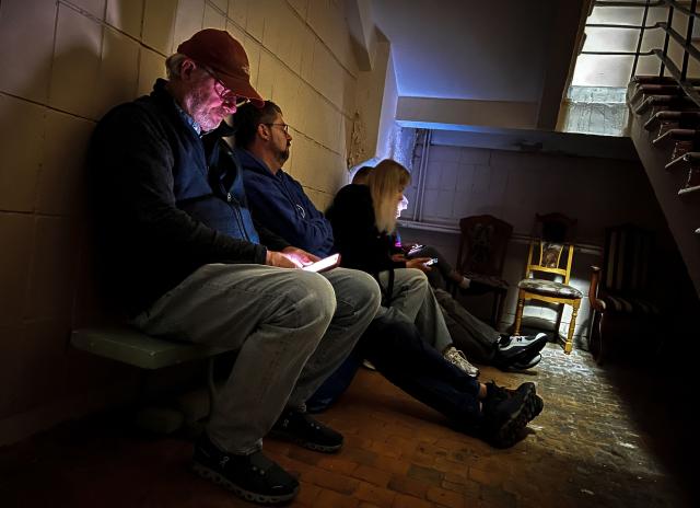 Hotel guests sit in the makeshift shelter at the basement of a hotel in Kyiv during a heavy missile and drone strike on the Ukrainian capital, on September 8, 2026, amid the Russian invasion of Ukraine. A series of "strong" explosions rang out in Kyiv, AFP journalists said early September 8, as Russia resumed strikes on the Ukrainian capital after a three-day halt. (Photo by Mladen ANTONOV / AFP)