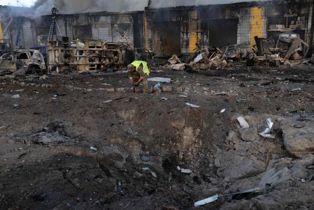 A rescuer examines a crater following Russian missile strikes amid Russia's invasion of Ukraine, in Kyiv early on September 8, 2026. A wave of strong explosions rang out in Kyiv, AFP journalists said early on September 8, as Russia resumed strikes on the Ukrainian capital after a three-day halt. (Photo by Serhii Okunev / AFP)
