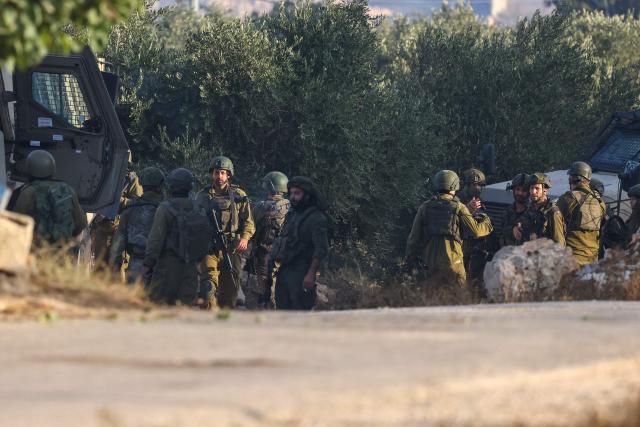Israeli soliders gather during a military operation after a Palestinian man barricaded himself inside a home in the Israel-occupied West Bank village of Aqraba, south of the city of Nablus on September 8, 2026. The house was later destroyed by the Israeli military. (Photo by JAAFAR ASHTIYEH / AFP)