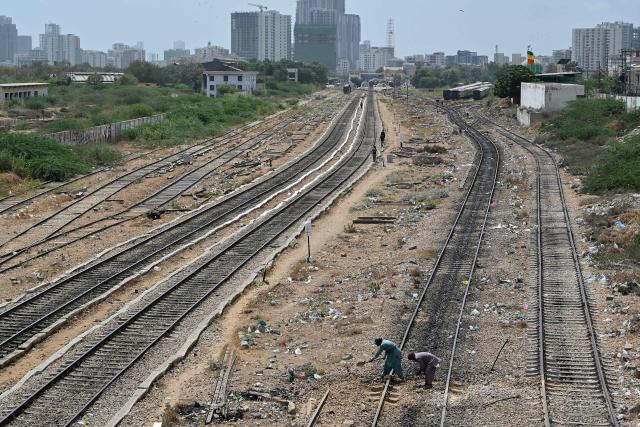 Workers carry out repair and maintenance work on a railway track in Karachi on September 8, 2026. (Photo by Asif HASSAN / AFP)