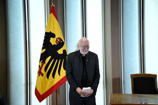 Hungarian writer and Literature Nobel Prize laureate László Krasznahorkai reeacts after his reading during the award ceremony for the Grand Cross of Merit with Star he received from the German President  in Berlin, on September 8, 2026. (Photo by Tobias SCHWARZ / AFP)