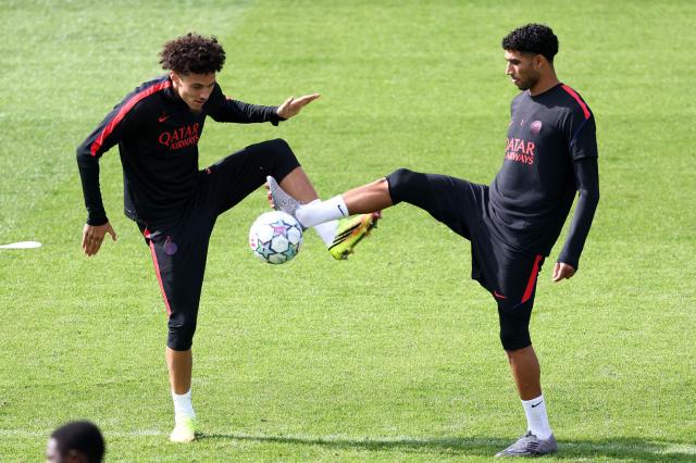 Paris Saint-Germain's French forward #11 Maghnes Akliouche (L) fighst the ball with Paris Saint-Germain's Moroccan defender #02 Achraf Hakimi  during a training session at the Campus Paris Saint-Germain in Poissy, on September 8, 2026, on the eve of the UEFA Champions League first round day 1 football match between Paris Saint Germain and Slovan Bratislava. (Photo by FRANCK FIFE / AFP)