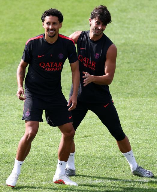 Paris Saint-Germain's Brazilian defender #05 Marquinhos (L) sarhes a laugh with PSG's Spanish forward #09  Ferran Torres during a training session at the Campus Paris Saint-Germain in Poissy, on September 8, 2026, on the eve of the UEFA Champions League first round day 1 football match between Paris Saint Germain and Slovan Bratislava. (Photo by FRANCK FIFE / AFP)