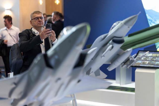 A man takes pictures of jet fighters models at one of the stands on the first day of the 34th International Defence Industry Exhibition in Kielce, Poland, on September 8, 2026. The 34th International Defence Industry Exhibition runs from September 8 to 11, 2026 in Kielce, Poland. (Photo by Wojtek RADWANSKI / AFP)