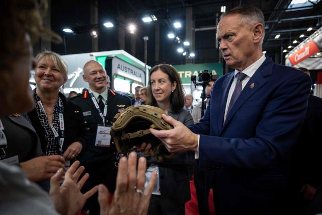 Canada’s Defence Minister David McGuinty (R) holds combat helmet and speaks to the exhibitors on the first day of the 34th International Defence Industry Exhibition in Kielce, Poland, on 8 September 2026. The 34th International Defence Industry Exhibition runs from September 8 to 11, 2026 in Kielce, Poland. (Photo by Wojtek RADWANSKI / AFP)