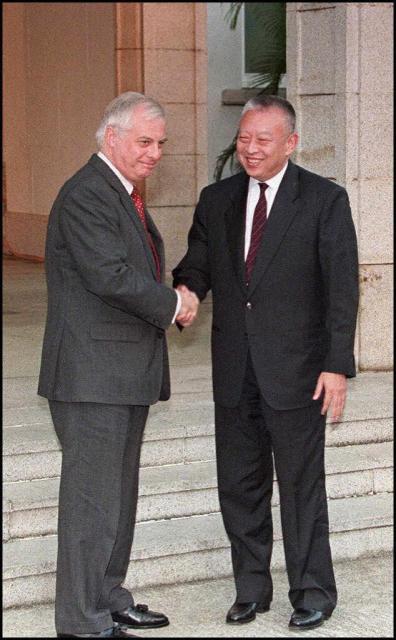 (FILES) Governor of Hong Kong Chris Patten (L) shakes hands with Hong Kong Chief Executive-elect Tung Chee-hwa after their first official meeting in Hong Kong on December 23 1996. Hong Kong's first post-colonial leader Tung Chee-hwa has died aged 89, his office said early September 9, 2026.  Tung, who served as Hong Kong's chief executive from 1997 to 2005, "passed away peacefully in the presence of his beloved family members" on September 8, a statement from his office said. (Photo by Peter PARKS / AFP)