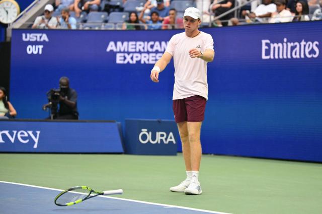 USA's Alex Michelsen throws his racquet after losing a point against USA's Frances Tiafoe during their men's singles quarter-final tennis match on day ten of the US Open tennis tournament at the USTA Billie Jean King National Tennis Center in New York on September 8, 2026. (Photo by ANGELA WEISS / AFP)