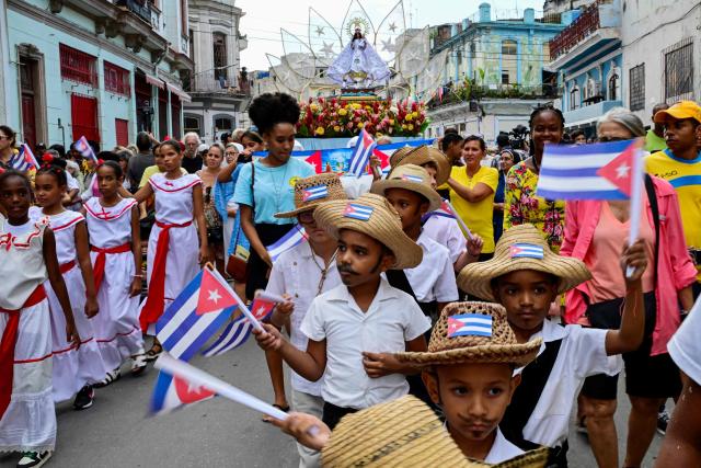 Followers of the Virgin of Charity, Oxun in the Yoruba religion, attend a procession during the Oxun Day celebrations in Havana on September 8, 2026. (Photo by YAMIL LAGE / AFP)