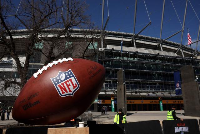 Construction workers put up signs at the Melbourne Cricket Ground in Melbourne on September 9, 2026. The first-ever regular-season NFL game in Australia takes place at the Melbourne Cricket Ground on September 11, 2026, featuring the San Francisco 49ers and the Los Angeles Rams. (Photo by Martin KEEP / AFP)