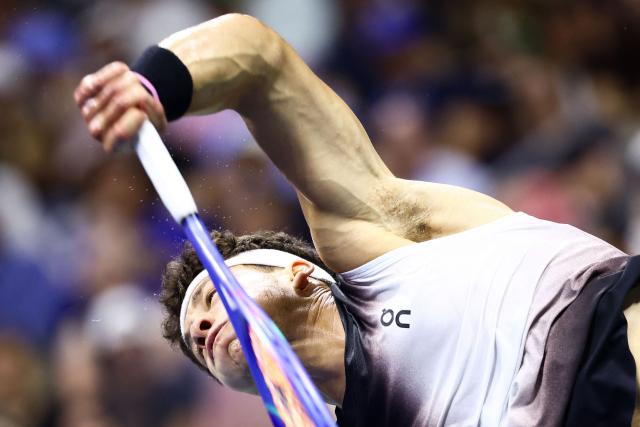 USA's Ben Shelton hits a return against Spain's Carlos Alcaraz during the men's singles quarter-final tennis match on day ten of the US Open tennis tournament at the USTA Billie Jean King National Tennis Center in New York City on September 8, 2026. (Photo by CHARLY TRIBALLEAU / AFP)