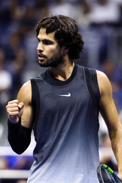 Spain's Carlos Alcaraz reacts after a point against USA's Ben Shelton during the men's singles quarter-final tennis match on day ten of the US Open tennis tournament at the USTA Billie Jean King National Tennis Center in New York City on September 8, 2026. (Photo by CHARLY TRIBALLEAU / AFP)
