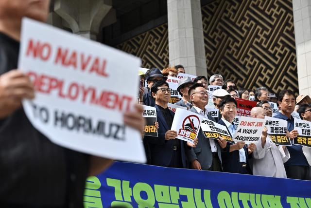 People protest against South Korea’s potential military involvement in the US operations in the Strait of Hormuz, in Seoul on September 9, 2026. (Photo by Lillian SUWANRUMPHA / AFP)