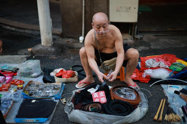 A vendor waits for customers at a second-hand market in Xiamen, in China’s eastern Fujian province on September 9, 2026. (Photo by CN-STR / AFP) / China OUT