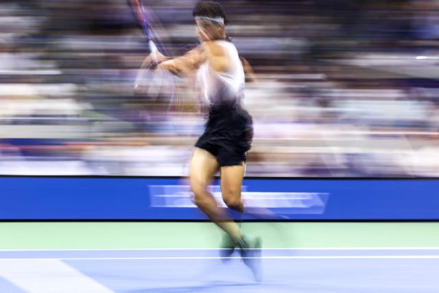 USA's Ben Shelton hits a return against Spain's Carlos Alcaraz during the men's singles quarter-final tennis match on day ten of the US Open tennis tournament at the USTA Billie Jean King National Tennis Center in New York City on September 8, 2026. (Photo by CHARLY TRIBALLEAU / AFP)