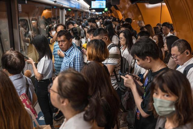 People wait to enter a train at a railway station in Hong Kong on September 9, 2026. (Photo by Dale DE LA REY / AFP)