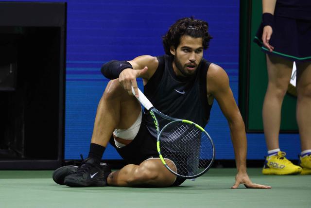 Spain's Carlos Alcaraz recovers after falling during the men's singles quarter-final tennis match against USA's Ben Shelton on day ten of the US Open tennis tournament at the USTA Billie Jean King National Tennis Center in New York City on September 9, 2026. (Photo by Leonardo MUNOZ / AFP)