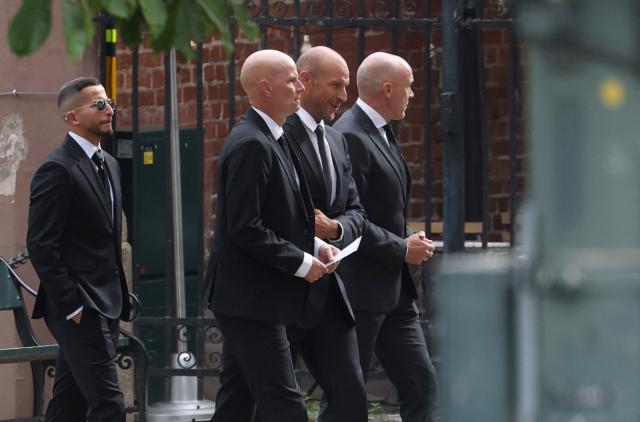 Norway's national football team's head coach Staale Solbakken (3rd R) and Norwegian former World Cup alpine ski racer Aksel Lund Svindal (2nd R) walk to the church as guests arrive to attend the funeral service for Norway's late King Harald V at the Oslo Cathedral in Oslo, Norway, on September 9, 2026. Harald, who died on August 28, 2026 at the age of 89, will be laid to rest in the crypt of the royal mausoleum of Akershus Castle, a medieval fortress overlooking Oslo Fjord, after a service at the Oslo Cathedral. (Photo by Odd ANDERSEN / AFP)