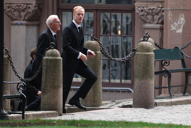Norwegian businessman and retired cross-country skier Bjoern Daehlie (R) walks to the church as guests arrive to attend the funeral service for Norway's late King Harald V at the Oslo Cathedral in Oslo, Norway, on September 9, 2026. Harald, who died on August 28, 2026 at the age of 89, will be laid to rest in the crypt of the royal mausoleum of Akershus Castle, a medieval fortress overlooking Oslo Fjord, after a service at the Oslo Cathedral. (Photo by Odd ANDERSEN / AFP)