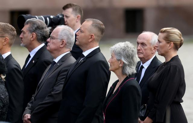 Denmark's Prime Minister Mette Frederiksen (R) and Poland's President Karol Nawrocki (C) arrive at the church as they walk during the royal procession accompanying the casket of late King Harald V of Norway from the Royal Palace Chapel to the Cathedral in Oslo, Norway, on September 9, 2026. Harald, who died on August 28, 2026 at the age of 89, will be laid to rest in the crypt of the royal mausoleum of Akershus Castle, a medieval fortress overlooking Oslo Fjord, after a service at the Oslo Cathedral. (Photo by Odd ANDERSEN / AFP)