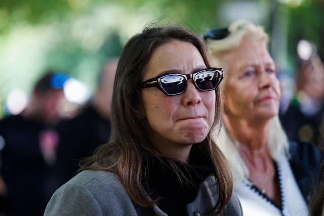 A woman reacts as the casket of late King Harald V of Norway is transferred during a royal procession from the Royal Palace Chapel to the Cathedral in Oslo on September 9, 2026. King Harald V died on August 28, 2026 aged 89 and his coffin will be carried in a funeral procession from the Royal Palace along Karl Johans gate to Oslo Cathedral on September 9, 2026. (Photo by Silje Katrine Robinson / NTB / AFP) / Norway OUT
