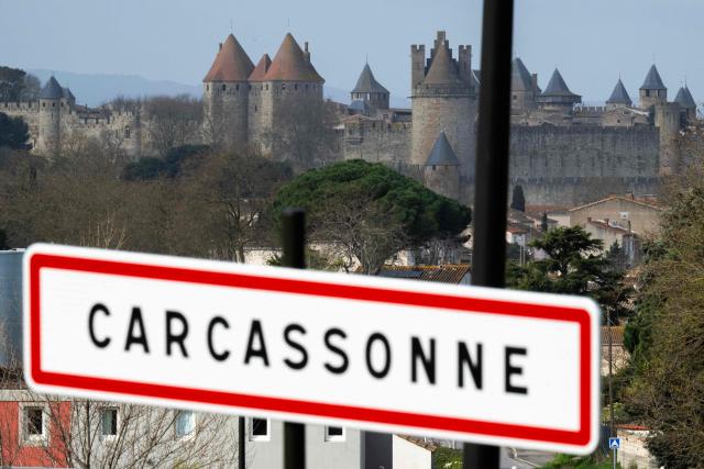 (FILES) This photograph shows the city entrance sign of Carcassonne with the medieval citadel in the background on March 12, 2026. A video showing city police officers in Carcassonne, southern France, making racist, sexist, and conspiracy-theory remarks, which is currently under investigation, sparked a storm of outrage on September 9, 2026. The Carcassonne prosecutors office told AFP that an investigation is already underway, without specifying when it began.


Translated with DeepL.com (free version) (Photo by Lionel BONAVENTURE / AFP)