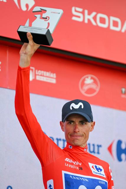 The overall race leader, Team Movistar's Spanish rider Enric Mas, celebrates on the podium following the 17th stage of the Vuelta a Espana 2026 cycling tour, a 185 km race between Dos Hermanas and Seville, on September 9, 2026. (Photo by JORGE GUERRERO / AFP)