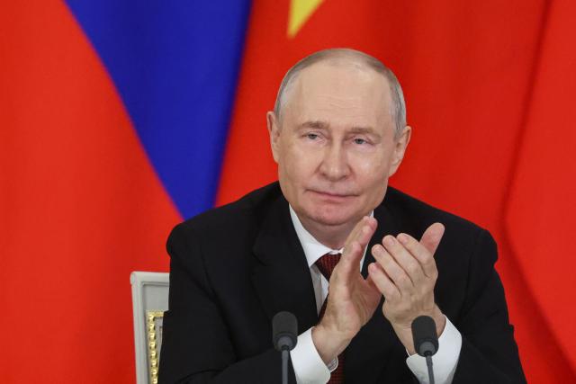 Russia's President Vladimir Putin applauds during the signing of documents following his talks with Vietnamese president in Moscow on September 9, 2026. (Photo by MAXIM SHIPENKOV / POOL / AFP)