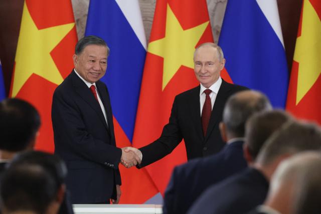 Russia's President Vladimir Putin (R) shakes hands with Vietnam's President To Lam (L) during the signing of documents following their talks in Moscow on September 9, 2026. (Photo by MAXIM SHIPENKOV / POOL / AFP)