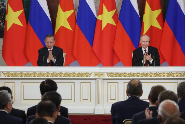 Russia's President Vladimir Putin (R)and Vietnam's President To Lam (L) applaud during the signing of documents following their talks in Moscow on September 9, 2026. (Photo by MAXIM SHIPENKOV / POOL / AFP)