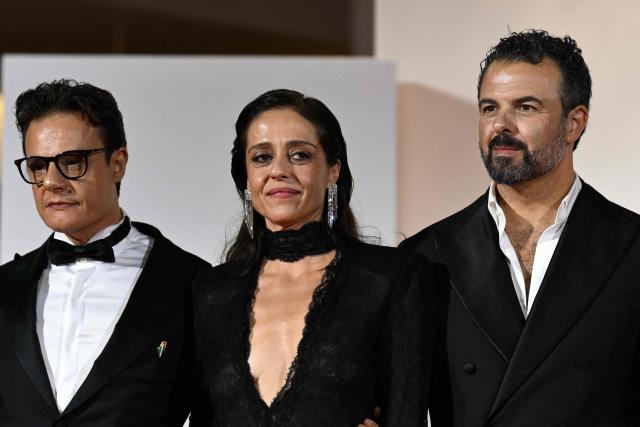 Director Edoardo De Angelis (R) and italian actors Lino Musella and Vanessa Scalera attend the red carpet event for the screening of "Il fuoco che ti porti dentro" (The Fire within you) presented in competition at the 83rd International Venice Film Festival, at Venice Lido on September 9, 2026. (Photo by Tiziana FABI / AFP)