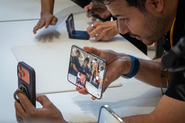 An attendee takes a selfie with the new foldable iPhone Duo, displayed during an Apple event at the Steve Jobs Theater in Apple Park in Cupertino, California, on September 9, 2026. Apple unveiled its long-awaited first foldable smartphone, the iPhone Duo, on Wednesday, at the company's first launch event since CEO John Ternus took the reins on September 1. Apple's first foldable comes seven years after Samsung pioneered the category, but the American tech giant is expected to take a sizable chunk of the market. (Photo by Karl Mondon / AFP)