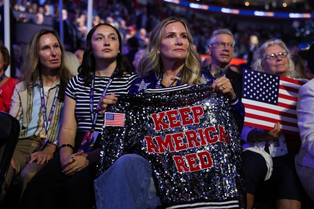 A woman holds a jacket reading "Keep America Red" during the Republican National Midterm Convention at the American Airlines Center in Dallas, Texas on September 9, 2026. US Republicans open an extraordinary midterm convention in Dallas on September 9 betting that putting Donald Trump at the center of their campaign can rescue a party facing grim election forecasts -- despite the president's negative approval ratings. (Photo by Blake Fagan / AFP)