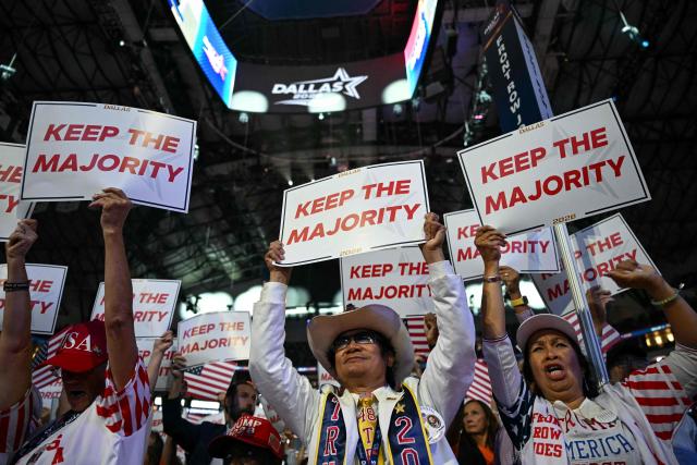 Attendees hold signs reading "Keep the majority" during the Republican National Midterm Convention at the American Airlines Center in Dallas, Texas on September 9, 2026. US Republicans open an extraordinary midterm convention in Dallas on September 9 betting that putting Donald Trump at the center of their campaign can rescue a party facing grim election forecasts -- despite the president's negative approval ratings. (Photo by RONALDO SCHEMIDT / AFP)