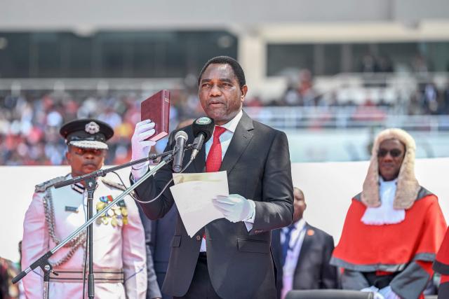 (FILES) Zambia's President Hakainde Hichilema (C) gestures during his swearing-in ceremony at the National Heroes Stadium in Lusaka, on September 1, 2026. The arrest of Zambia's main opposition leader Brian Mundubile and claims of irregularities, violence and an uneven playing field around the August election have intensified concerns that the country is drifting toward the democratic backsliding seen elsewhere on the continent. (Photo by Noel SICHALWE / AFP)