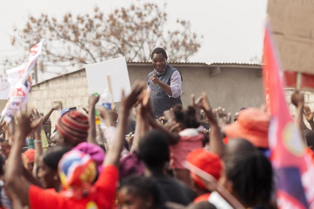 (FILES) Zambian incumbent President and United Party for National Development (UPND) presidential candidate Hakainde Hichilema waves at supporters as he arrives for an elections campaign rally in Lusaka on August 11, 2026. The arrest of Zambia's main opposition leader Brian Mundubile and claims of irregularities, violence and an uneven playing field around the August election have intensified concerns that the country is drifting toward the democratic backsliding seen elsewhere on the continent. (Photo by GIANLUIGI GUERCIA / AFP)