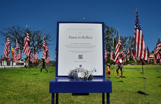 People walk among US flags displayed at Pepperdine University in Malibu, California, on September 9, 2026, as part of the annual Wave of Flags commemorating the September 11, 2001 attacks. (Photo by Frederic J. BROWN / AFP)