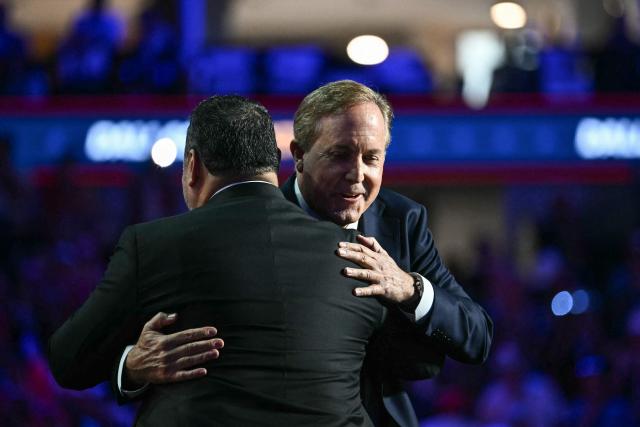 Texas Attorney General Ken Paxton (R), candidate for US Senate, hugs Paul Perez, President of the National Border Patrol Council, during the Republican National Midterm Convention at the American Airlines Center in Dallas, Texas on September 9, 2026. US Republicans open an extraordinary midterm convention in Dallas on September 9 betting that putting Donald Trump at the center of their campaign can rescue a party facing grim election forecasts -- despite the president's negative approval ratings. (Photo by Kent NISHIMURA / AFP)